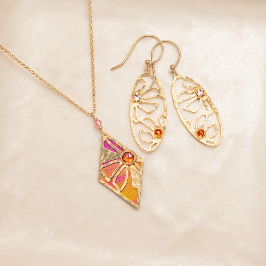 Holly Yashi Drew Earrings - Color gold - 18k gold-plated niobium dangles with crystal and amber cabochon next to matching necklace