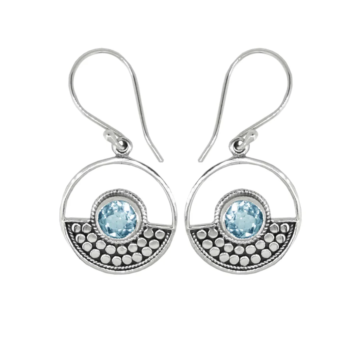 Sterling Silver design in a circle surrounds a circular blue topaz stone on ear wires. Half of the circle is dotted with an oxidized sterling design, the other half is open. On a plain white background.