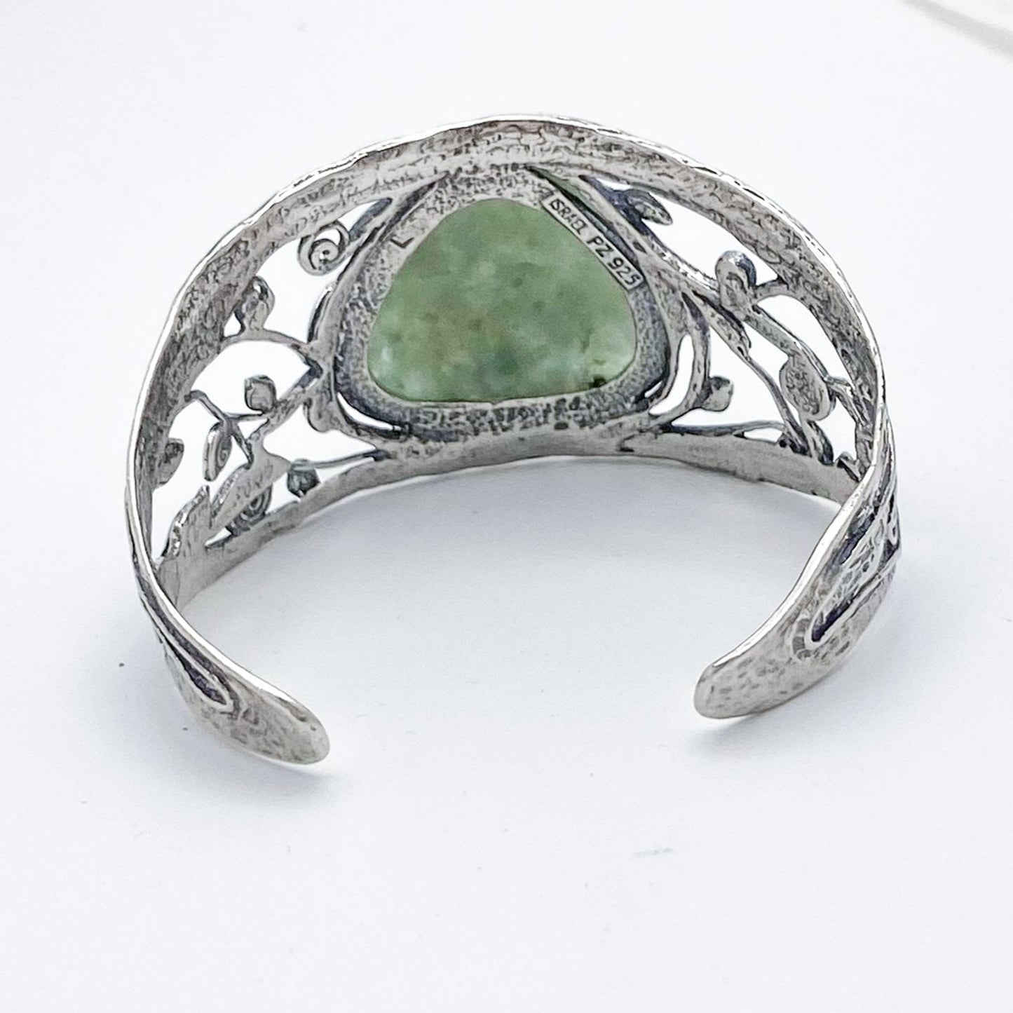 Large triangle shaped piece of Roman Glass set in a 925 Sterling Silver cuff bracelet - The band is adorned with vines and leaves and has a unique hammered appearance.