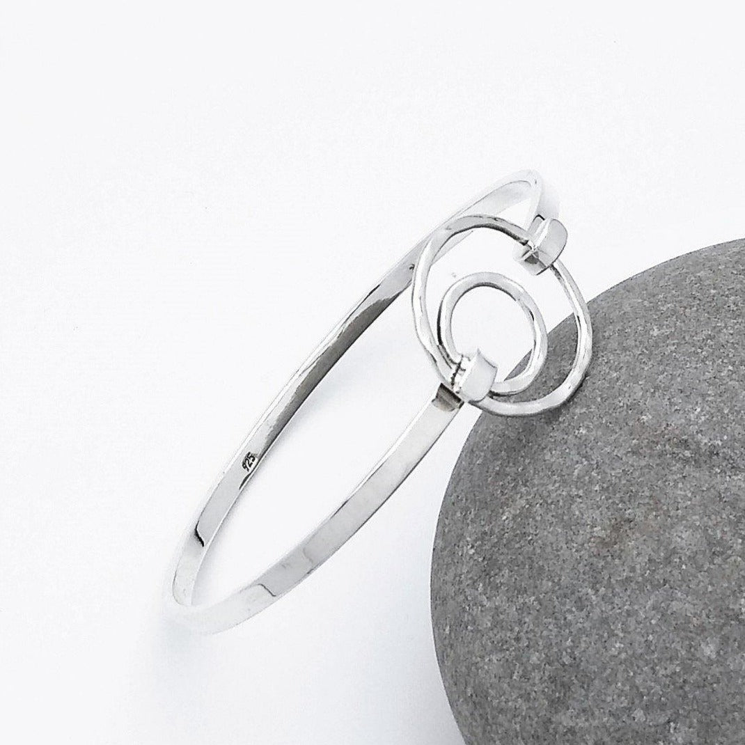 Via Taxco Clasp Bangle - slim band with a hammered circle and an offset smaller hammered circle inside that which holds the clasp.