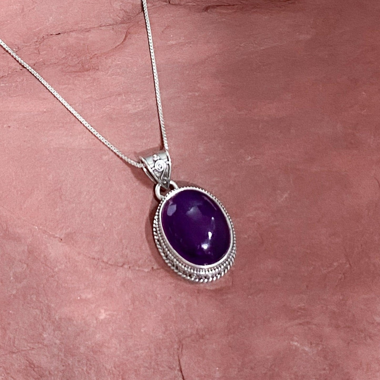 Amethyst Pendant In A Heavy Ornate setting . Dark purple. Cabachon stone. Urbansterlingsilver.com - Silver Parrot, Inc.