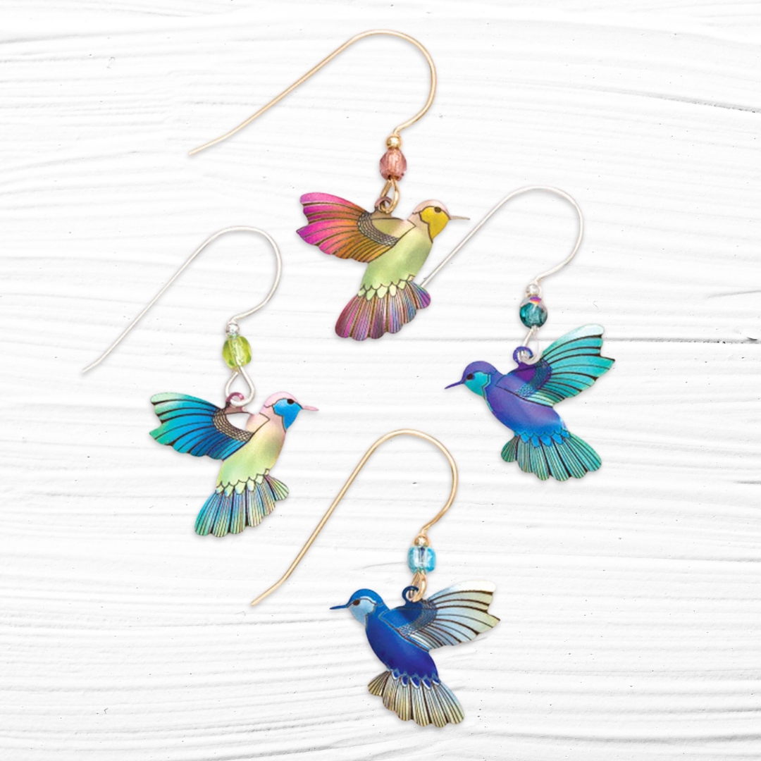 Holly Yashi Picaflor Hummingbird Dangles made out of Niobium. Earwires are either 925 sterling silver or gold filled, adorned with a Swarovski Crystal.  Four colors are available, Ultra Violet, Island Green, Blue Radiance, or Living Coral
