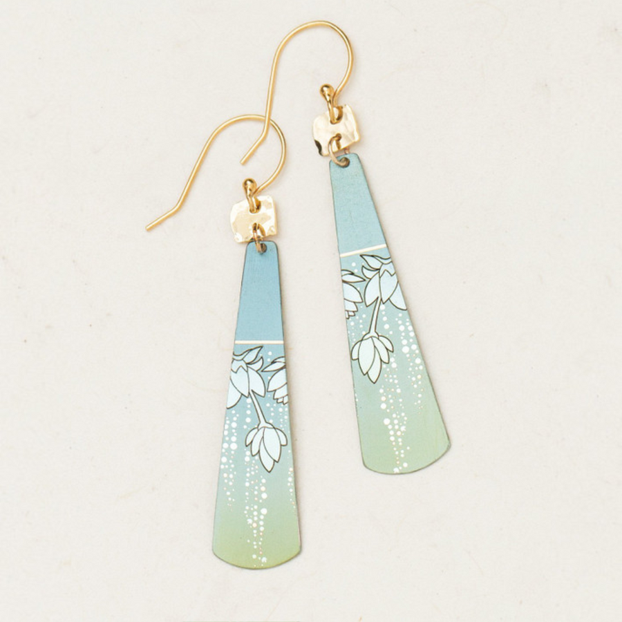 Introducing the Holly Yashi Tula Earrings, a stunning pair of tapered, elongated earrings with a captivating gradient design that transitions from light blue at the top to light green at the bottom. These earrings are adorned with a delicate white floral pattern, gold-plated hooks, and an iridescent Austrian sparkle for a truly romantic look.