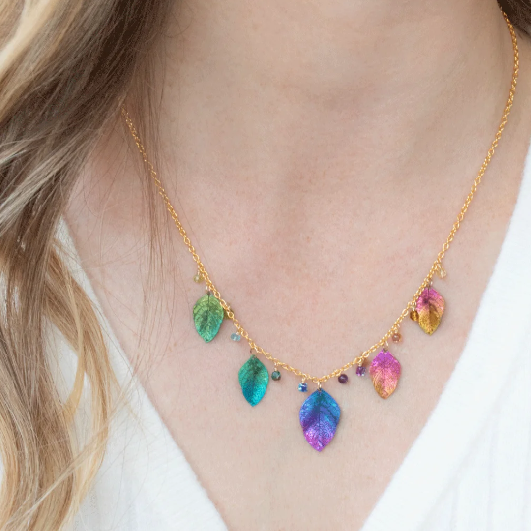 Holly Yashi Healing Elm Leaf Necklace - Color Rainbow - 18k gold-plated and niobium with crystal, glass, peridot, and apatite drops - shown on model