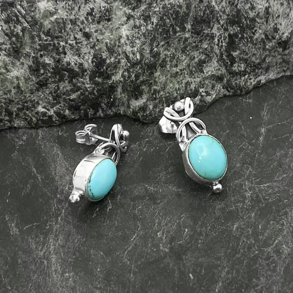 Handmade Navajo Turquoise Studs in a 925 Sterling Silver setting - Above the ovular stone is a knot design in silver and below is a small silver sphere.