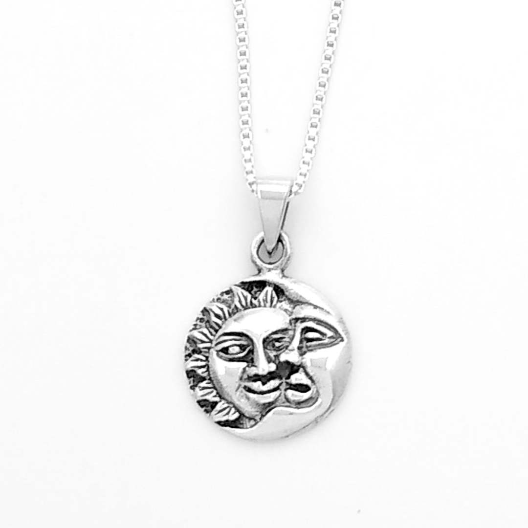 925 Sterling Silver necklace and simple box chain. The pendant is a medium circle design with a sun cast behind a crescent moon, both of them having a face. 
