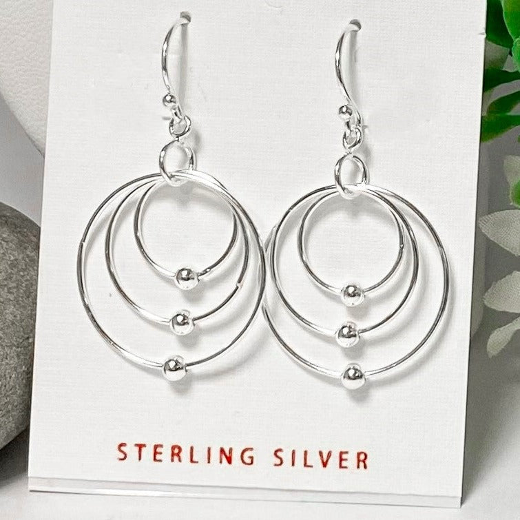 925 Sterling Silver Dangles comprised of three different sized hoops with a single ball on each, all connected by a jump ring and fish-hook earwires - on earring card