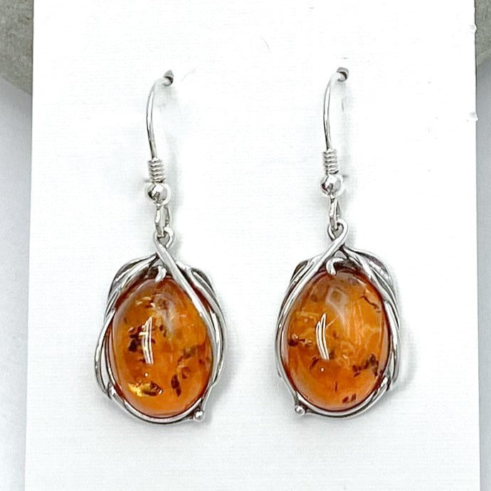 Oval shaped Baltic Amber in floral / vine-like 925 sterling silver setting on earring card