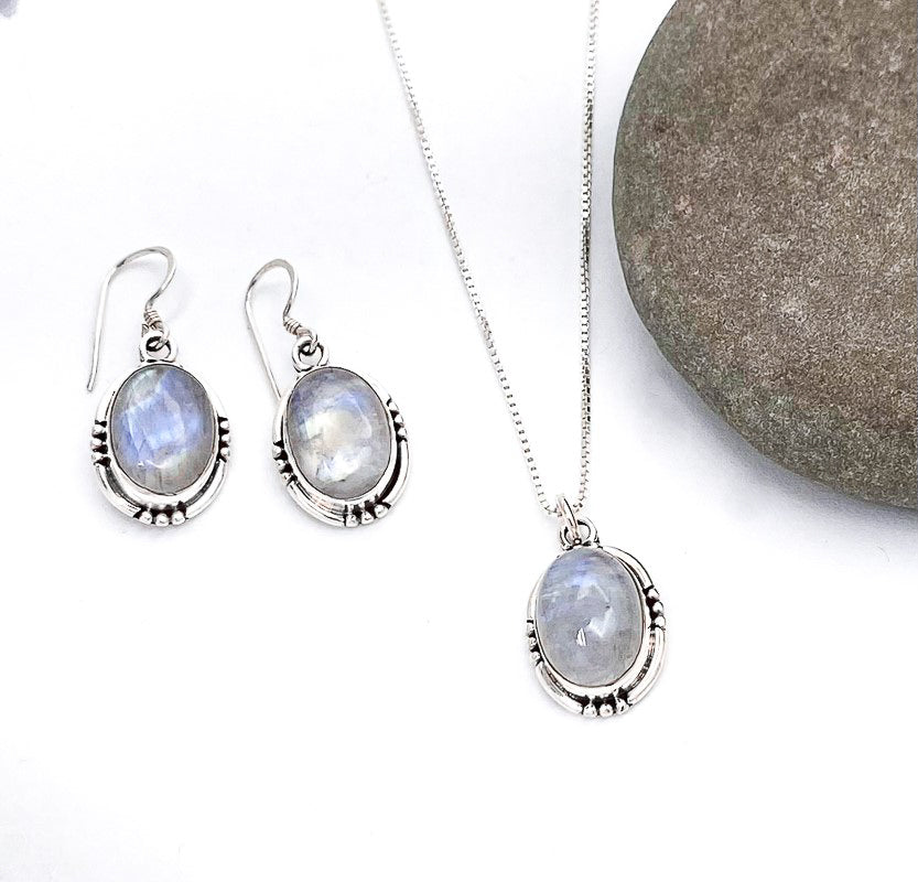 Medium sized oval shaped blue moonstone set in a simple 925 sterling silver setting, and laid on a simple 18" box chain.