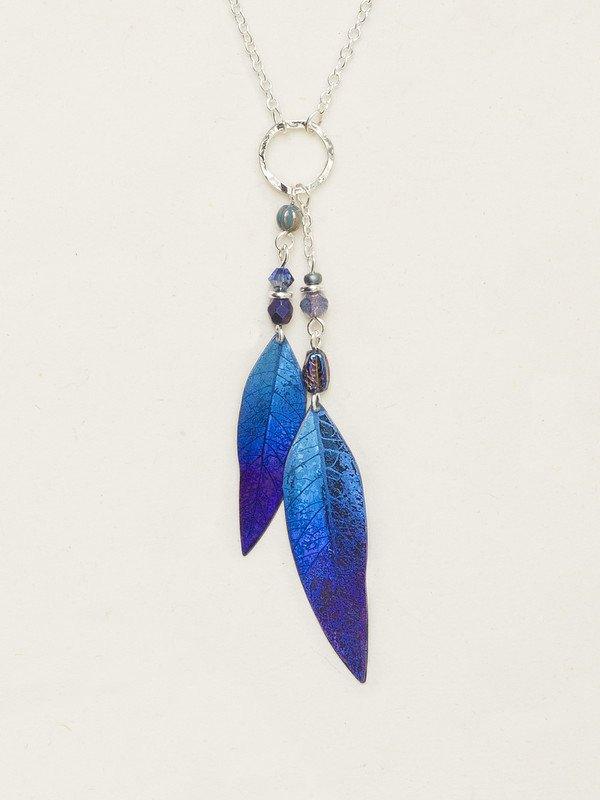 Light blue-to-dark blue gradient leaf with venations etched into the metal work. At the top of the leaf are two light blue beads, separated by a sterling silver chain. Leaves are attached to a gold circle, attached to a sterling chain.