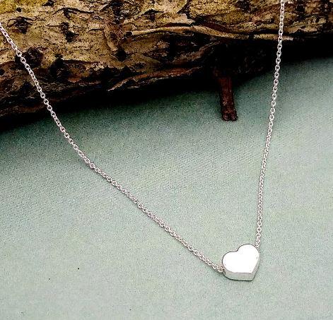 small sterling silver heart with a rolo style chain running through it.