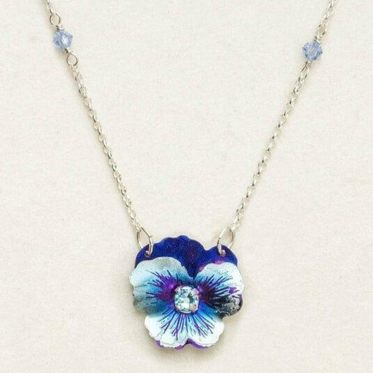 Niobium hand-crafted light blue pansy flower pendant attached to a sterling silver chain. Chain has a single light blue swarovski crystal linked into the metal about one and a half inches from the pendant.