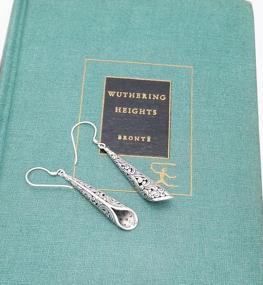 Sterling silver dangle earrings with intricate bali designs etched in the metalwork. Dangle on a French wire