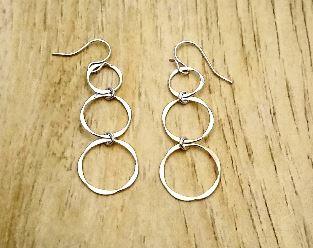 Silver earring with 3 circles dangling in a line. 2 inches long. Light and casual. Made in USA