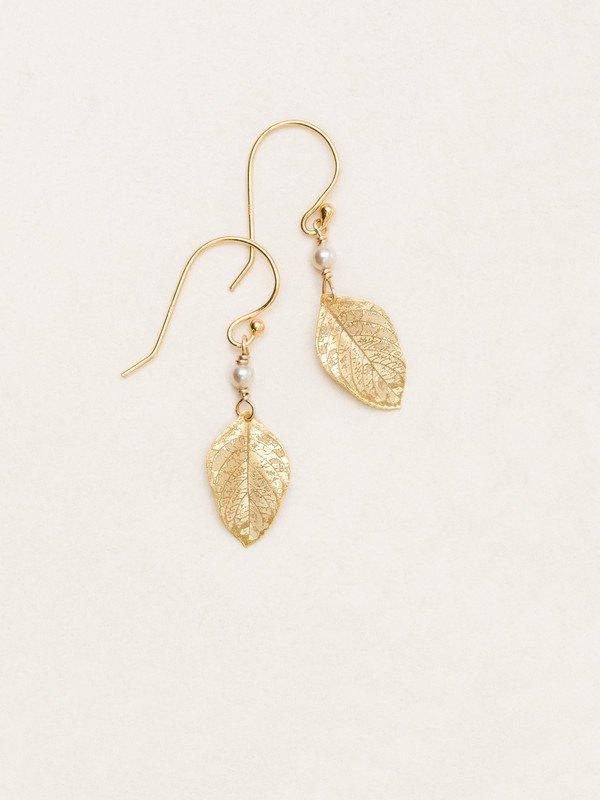 Beige niobium leaf dangling earrings with venation leaf veins etched in the metal on a gold-filled ear wire. At the top of the leaf is a white bead.