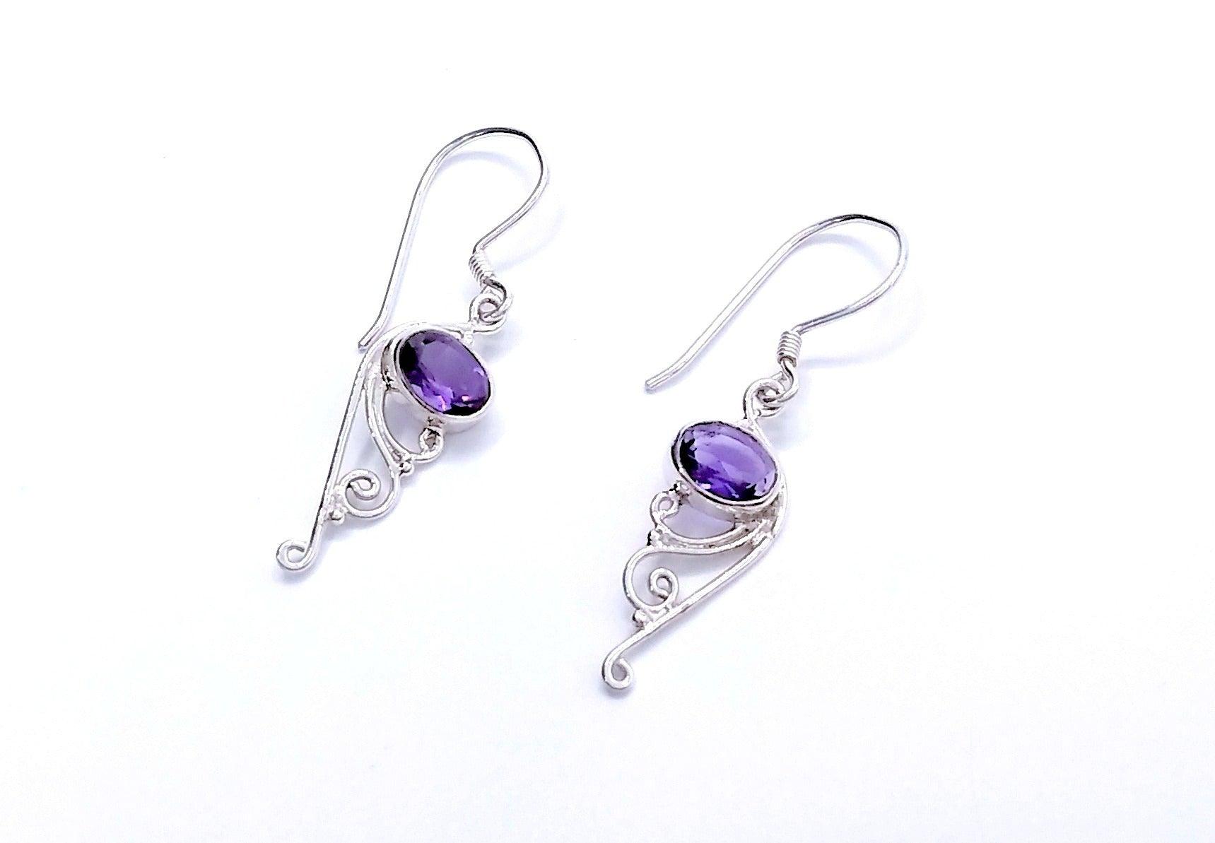 Sterling silver drop earrings on a French wire with an Amethyst stone at the top and filigree design at the bottom.