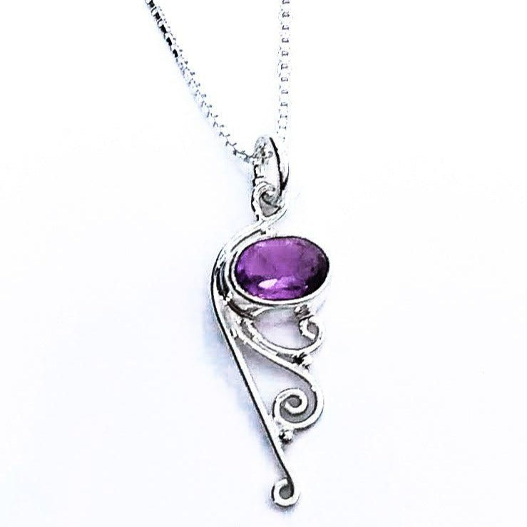 Sterling silver pendant with amethyst and filigree at the bottom.