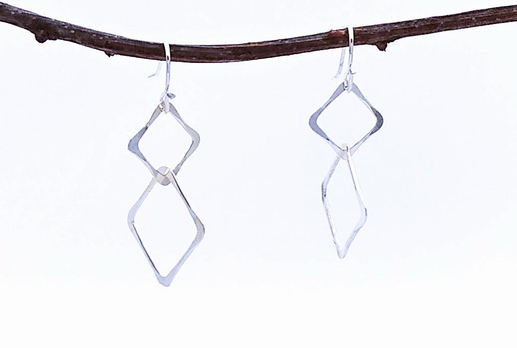 silver earrings with 2 connected hammered squarea. 1.25 inches long. Light.