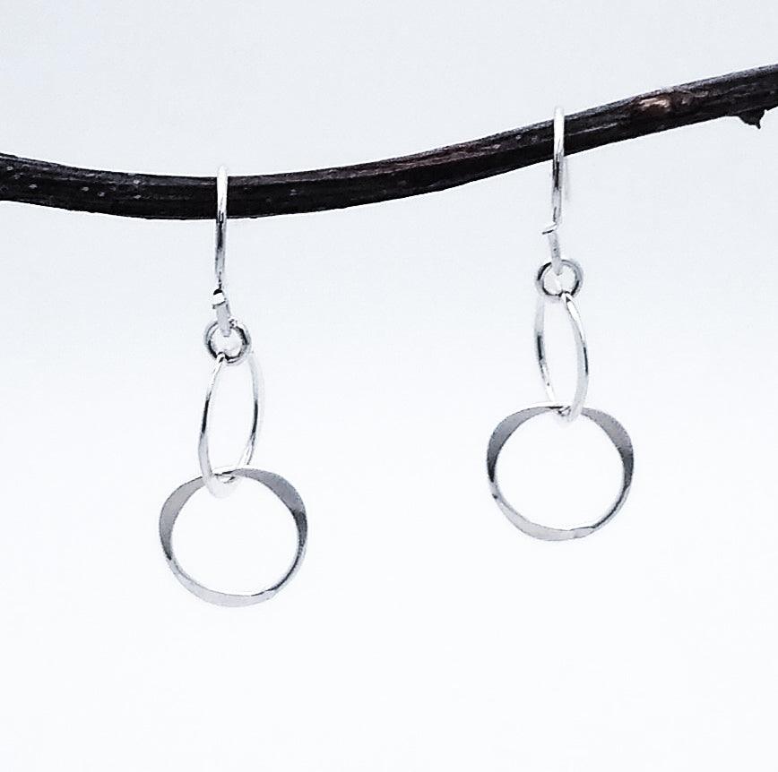 Silver dangle earrings. 2 connected circles hanging.1.25 inches long.