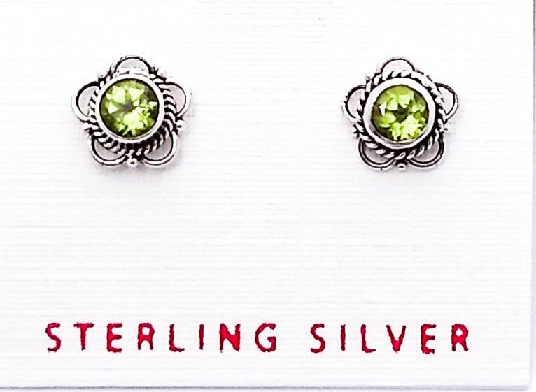 Sterling silver bali-design studs shaped in a floral pattern with a peridot in the middle. Peridot is the birthstone for August