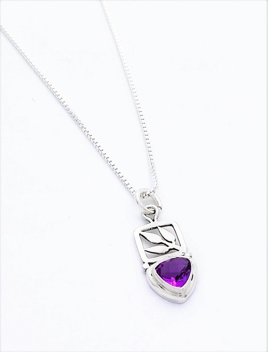 Sterling silver leaf cut out pendant with a small teardrop-shaped amethyst stone at the bottom