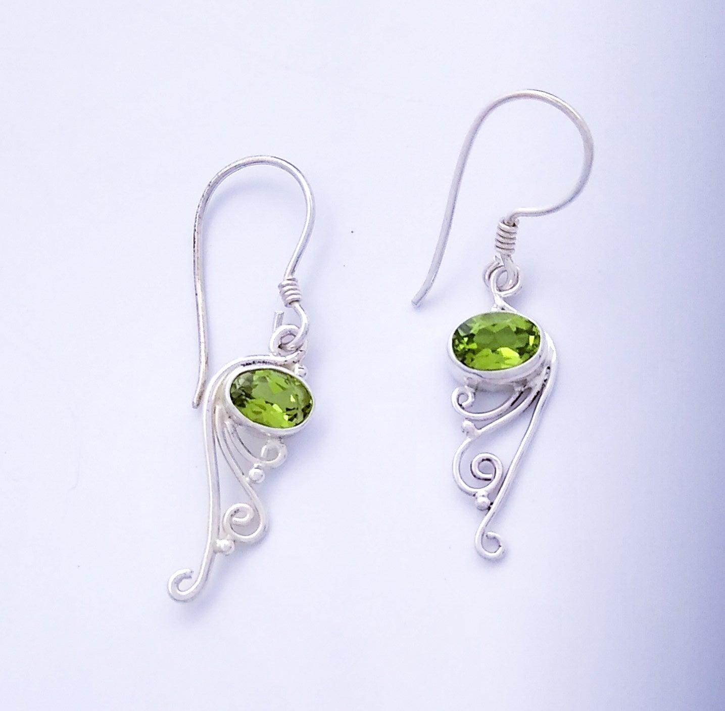 Sterling silver drop earrings on a French wire with an Peridot stone at the top and filigree design at the bottom.
