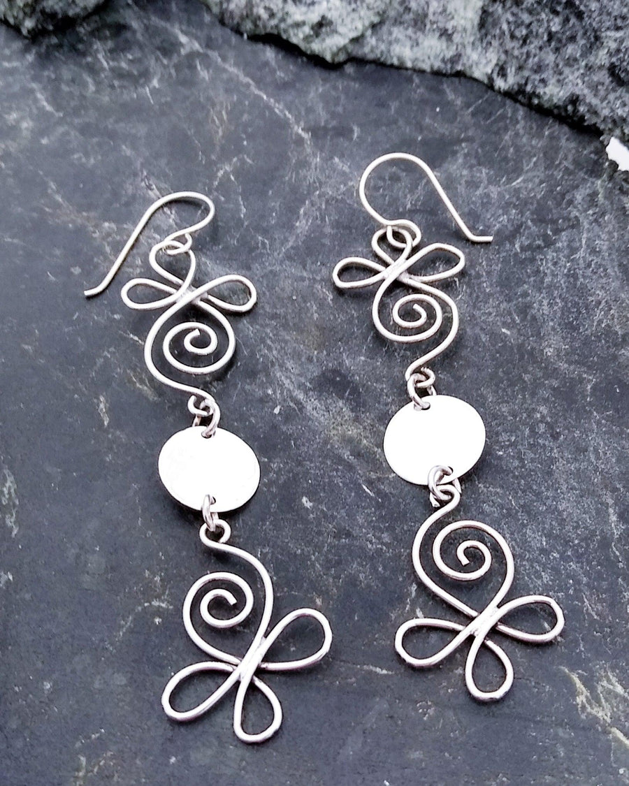 Sterling silver lightweight dangle earrings with a funky butterfly-esc design at the bottom, with a solid plate in the middle, connected to another hollow swirl design at the top. Connected to a French wire