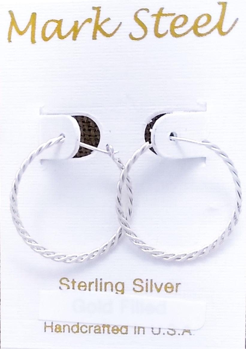 Sterling silver hoops of two woven strands meet in a peg-in-hole style closure.