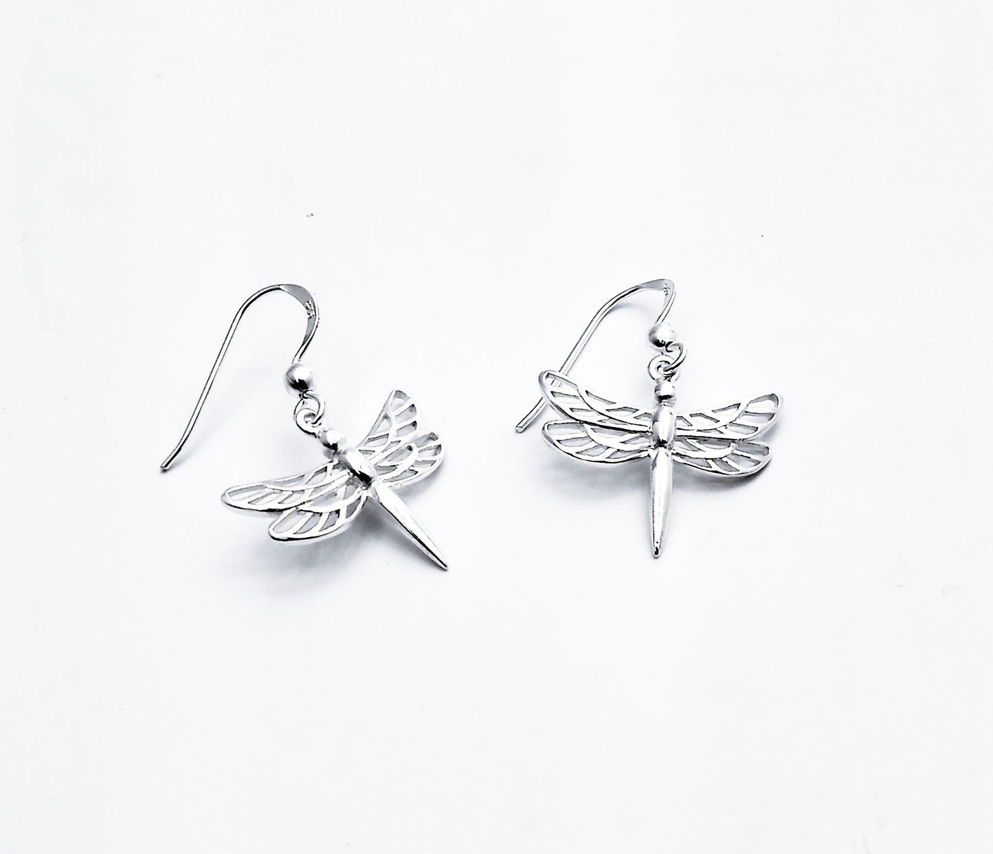 Sterling drop earring of dragonfly with 4 wings with cutout details and straight tail.