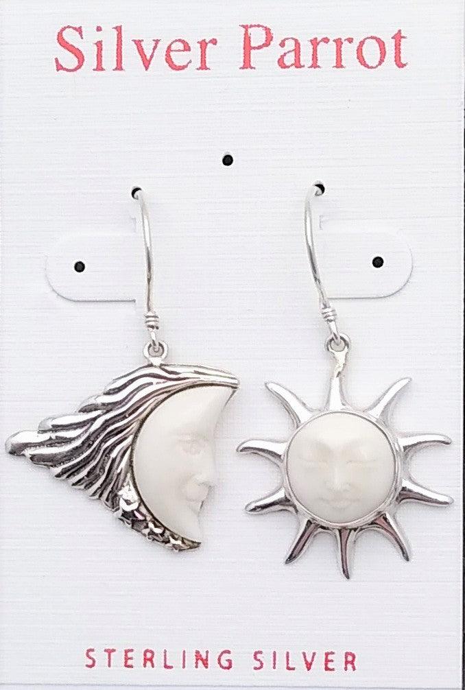 Sterling silver moon and sun dangle earrings. Moon is a half-moon made of white bone, with a sterling border. The sun is carved white bone with 10 outstretched sterling rays going out from the center