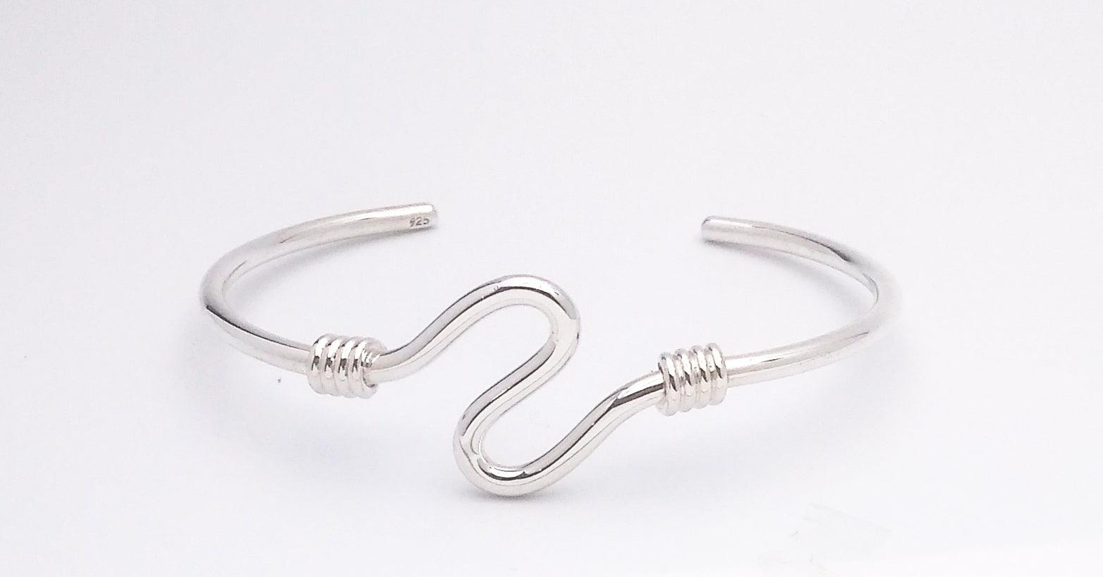 Sterling silver cuff bracelet with a wave design on the front