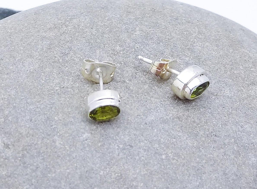 Plain sterling silver ovular stud earrings with Peridot stone in the middle. Peridot is the birthstone for August.