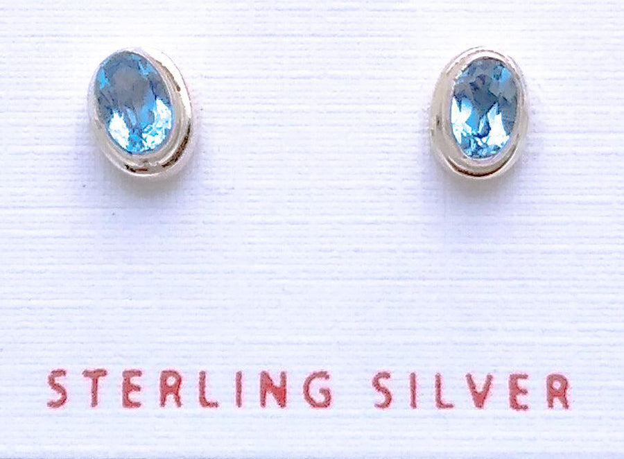 Plain sterling silver ovular stud earrings with Blue Topaz in the middle. Blue Topaz is the birthstone for December.