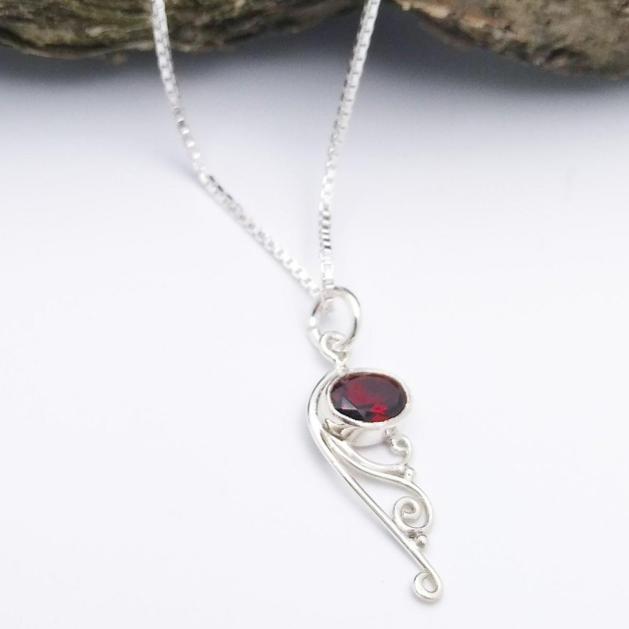 Sterling silver pendant with Garnet and filigree at the bottom.
