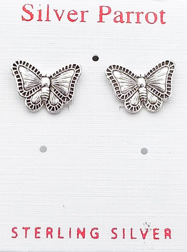 Close up view of sterling silver butterfly stud earrings displayed on a white Silver Parrot jewelry card. You can clearly see the patterned design of the butterfly's wings along the edges, with lines stretching from inner wing toward the outer pattern.