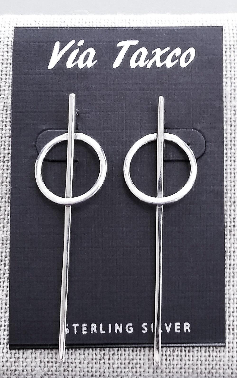 Sterling silver post earrings. A long, thin silver bar stretches through a circular hoop at the top of the earring.