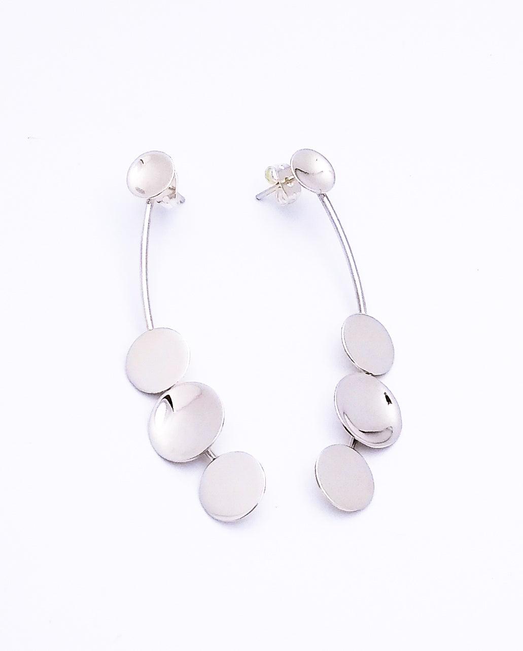 Sterling silver post earrings that dangle from the bottom with three silver discs at the bottom, and one disc at the top/