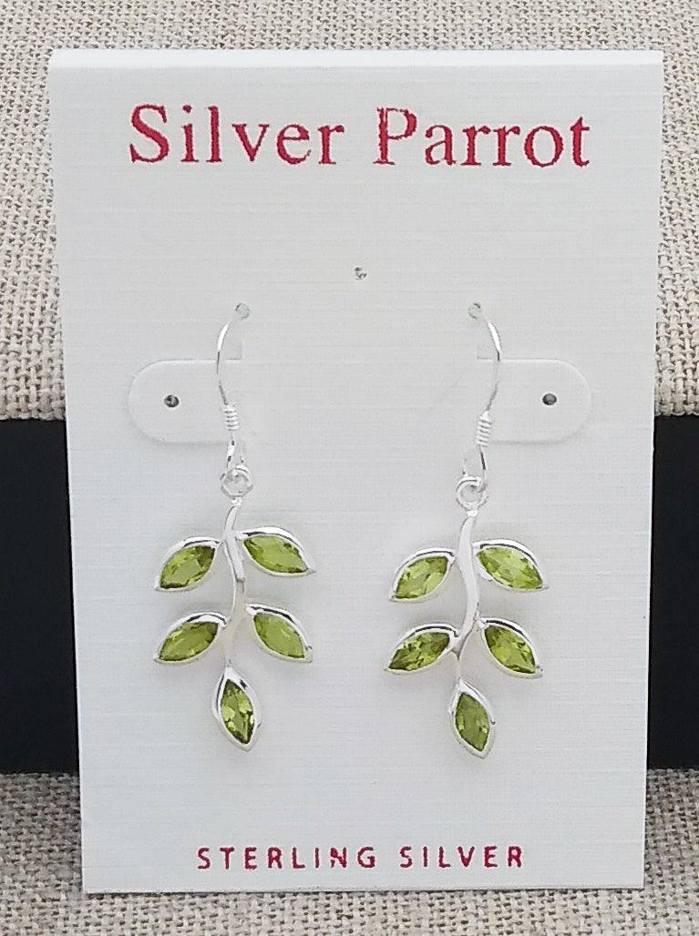 Sterling silver leaf earrings on a French wire. Five Peridot leaves extend from the center silver branch