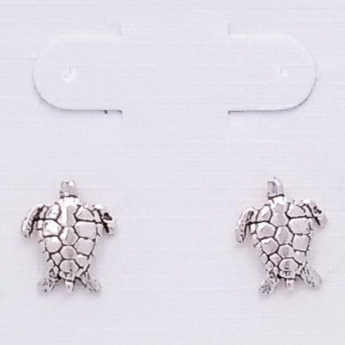 Sterling silver sea turtle studs. View from looking down onto a turtle, with designs etched into the metal work of the shell.
