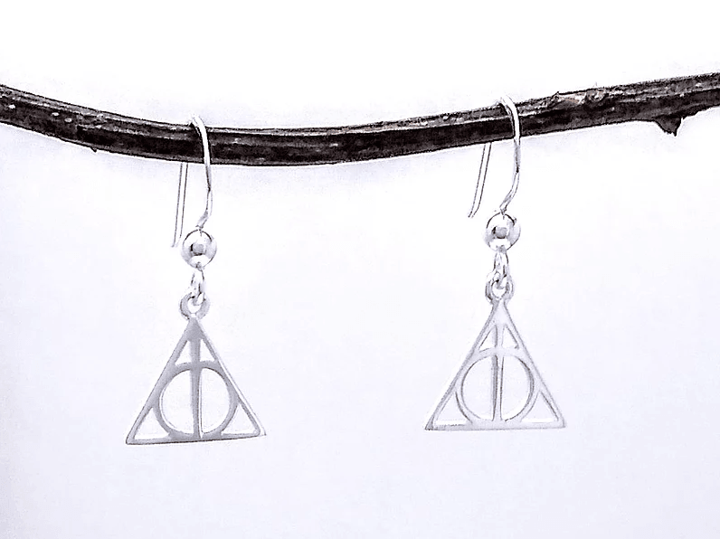 silver harry potter deathly hallows earring. there's a metal bar going through a circle, situated inside a small triangle.