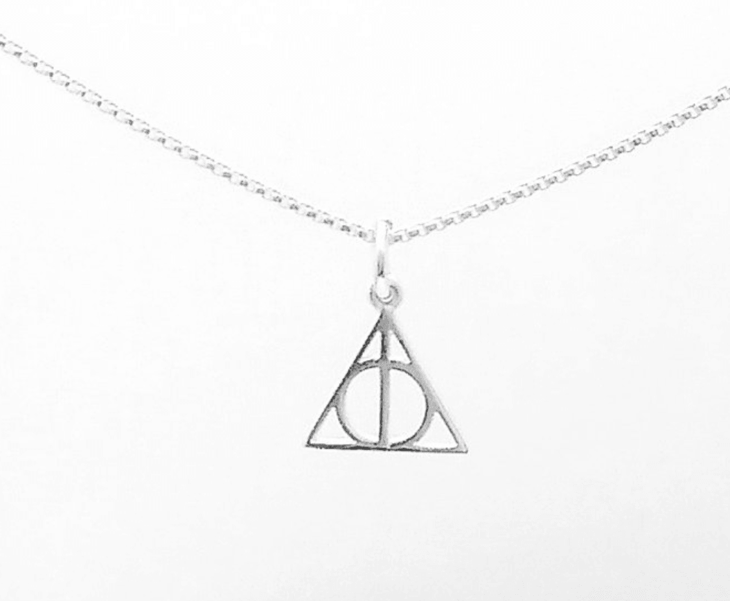 Harry potter necklace. Small circle in the middle cut down the middle with a silver bar, surrounded by a triangle.
