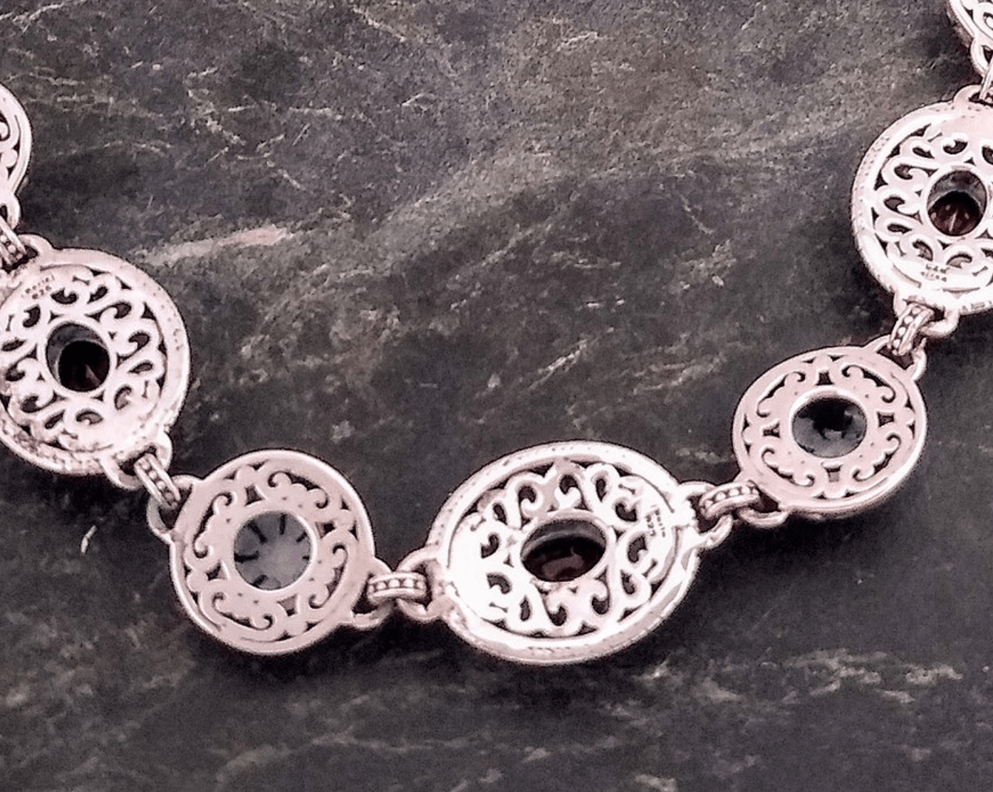 A back view of the bracelet reveals the handiwork of the skilled artisans with hand-crafted swirls underlining the silver links of the bracelet.