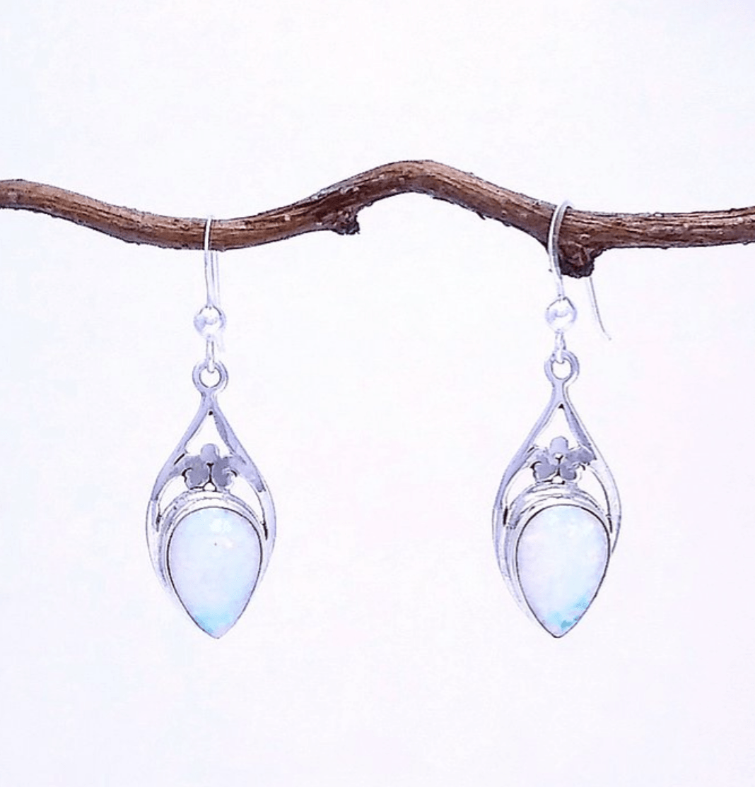 Sterling silver teardrop-shaped earrings with opal at the bottom and filigree at the top on a French wire