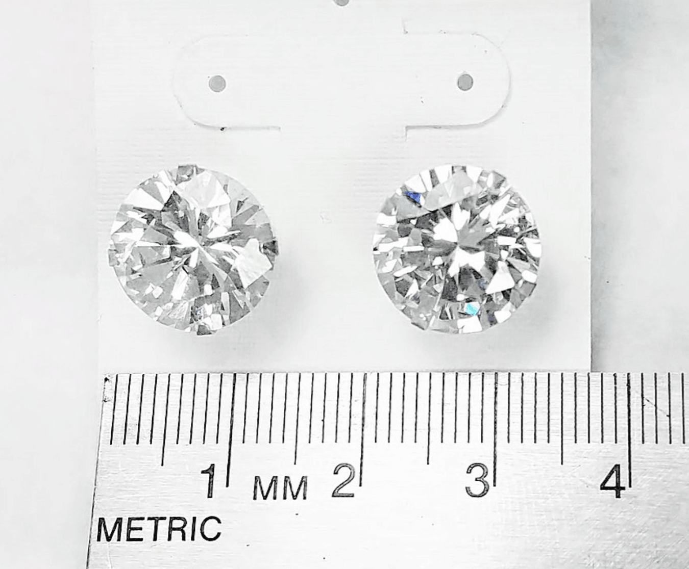 Cubic zirconium studs in sterling silver. A ruler shows each stud is 12mm across.