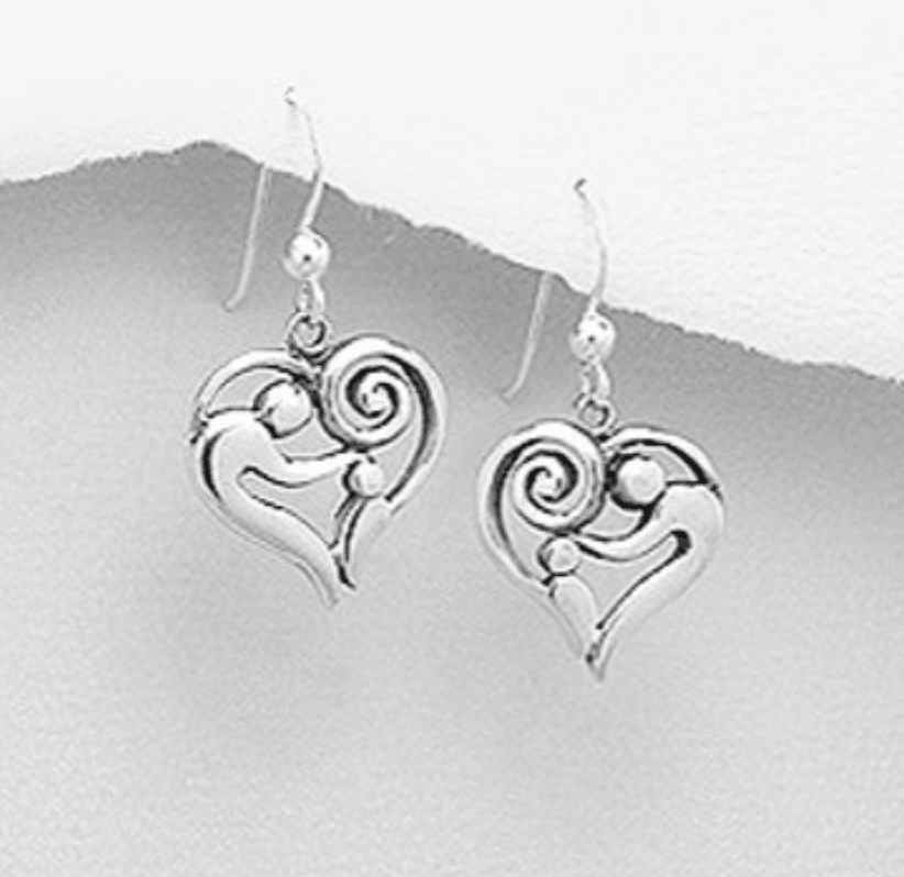 Heart shaped silver earrings depicting an adult touching the head of a child