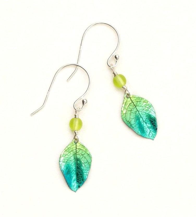 Light green and dark green niobium leaf dangling earrings with venation leaf veins etched into the metal on a sterling silver ear wire. At the top of the leaf is a bright green bead.