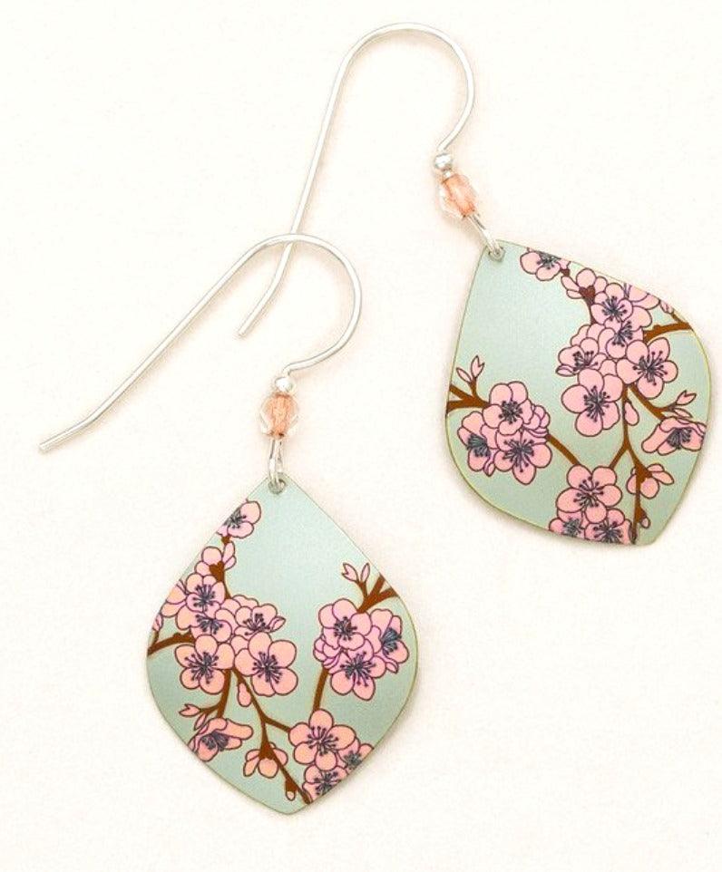 Diamond-shaped niobium earrings with pink cherry blossoms on a pale green background. Sterling silver ear wire has a small bead at the bottom.