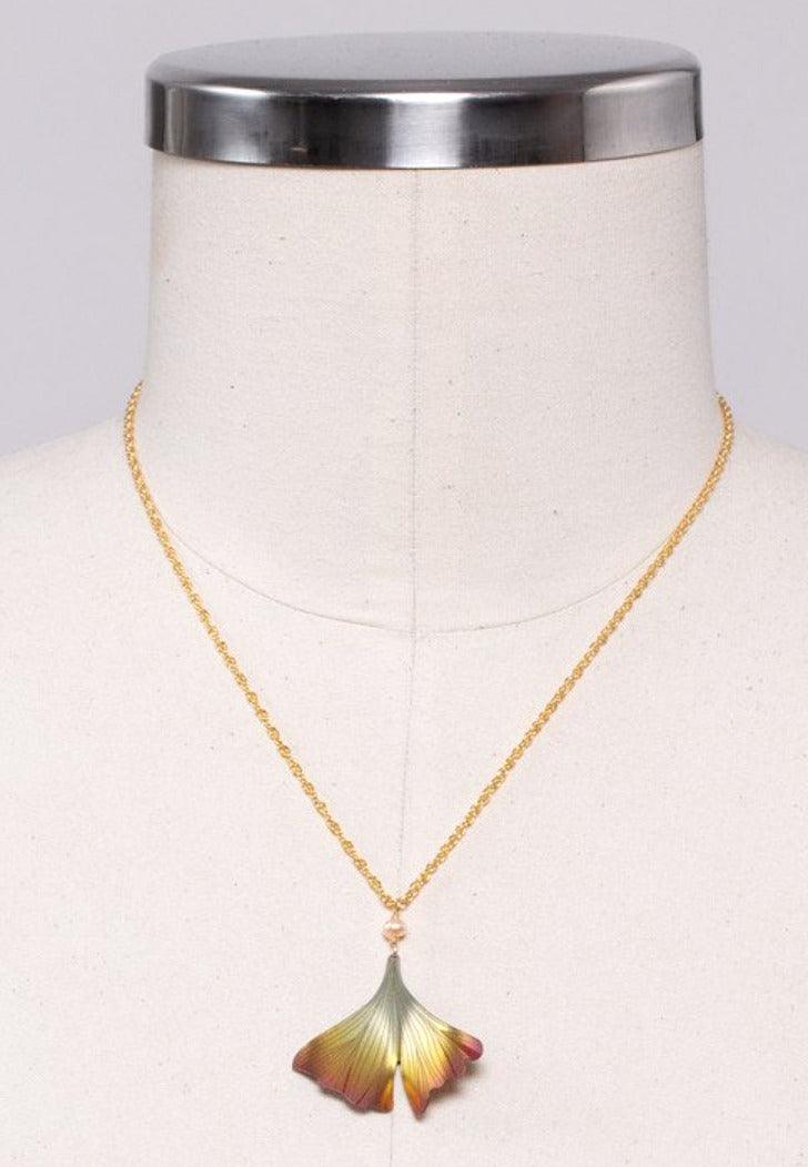 Gold ginkgo leaf drop necklace on a gold-filled adjustable chain, with a shiny gold bead separating the chain and leaf.