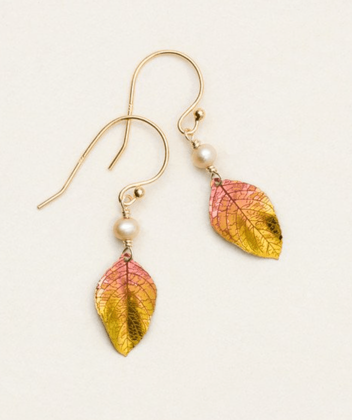 Red and gold niobium leaf dangling earrings with venation leaf veins etched in the metal on a gold-filled ear wire. At the top of the leaf is a creamy pear-colored bead.