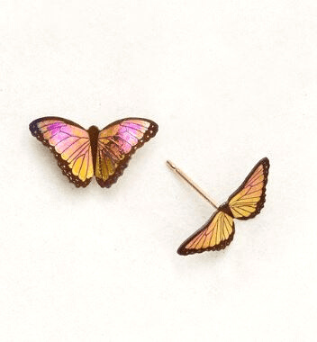 Vibrant orange-pink realistic butterfly on a gold post